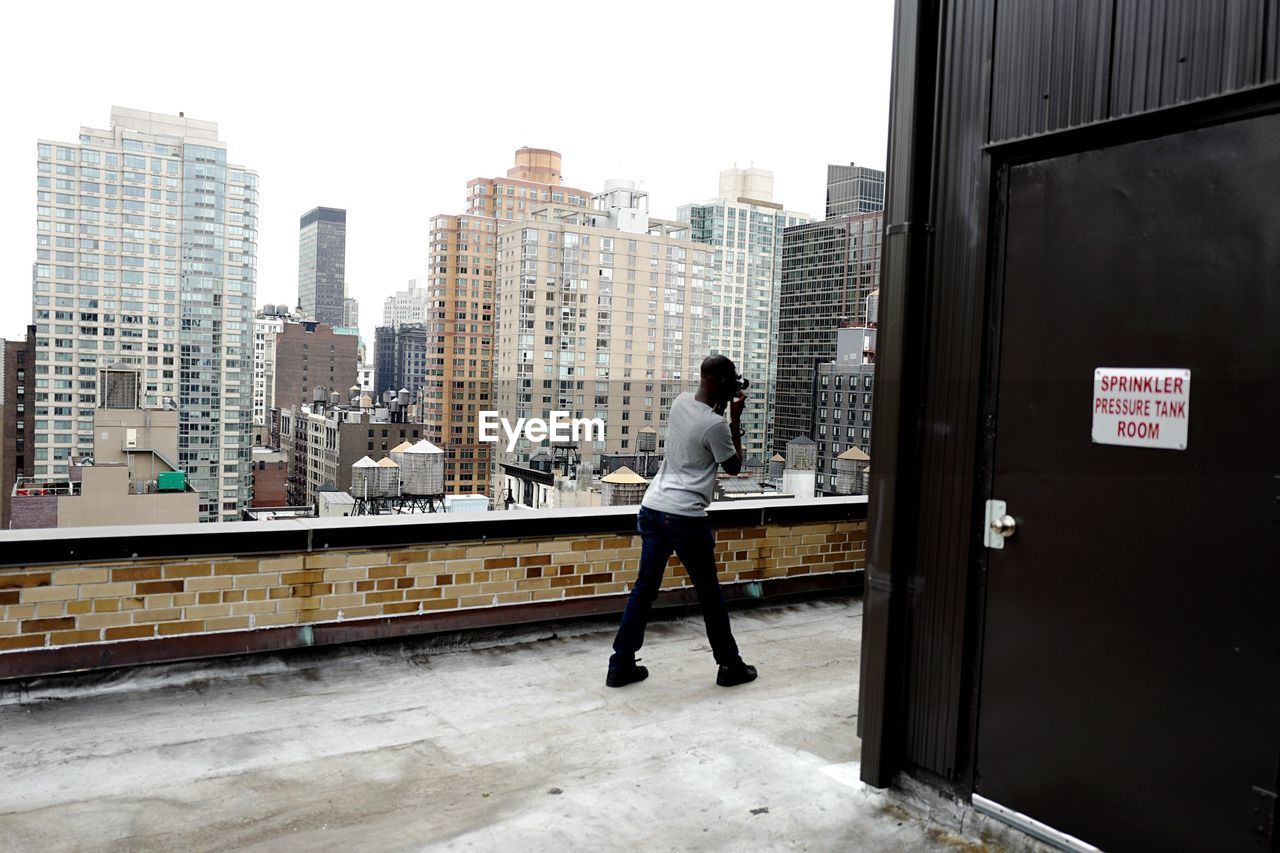 Man photographing on rooftop