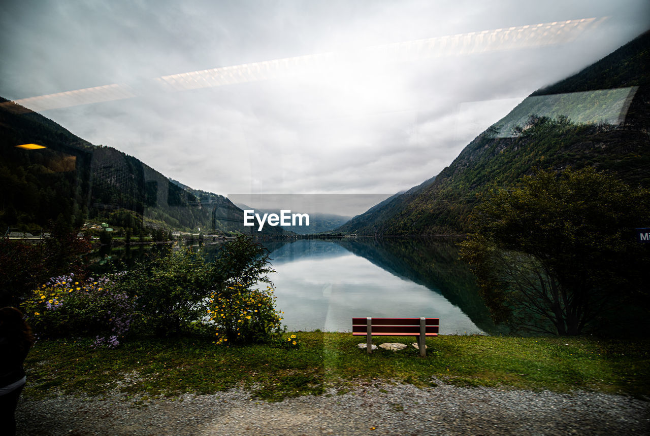 Scenic view of lake and mountains against sky