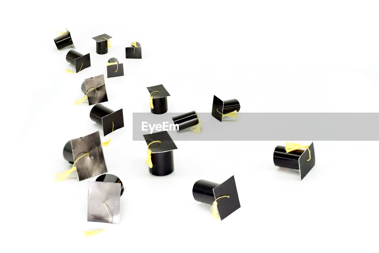 Close up small graduation caps isolated on white background.