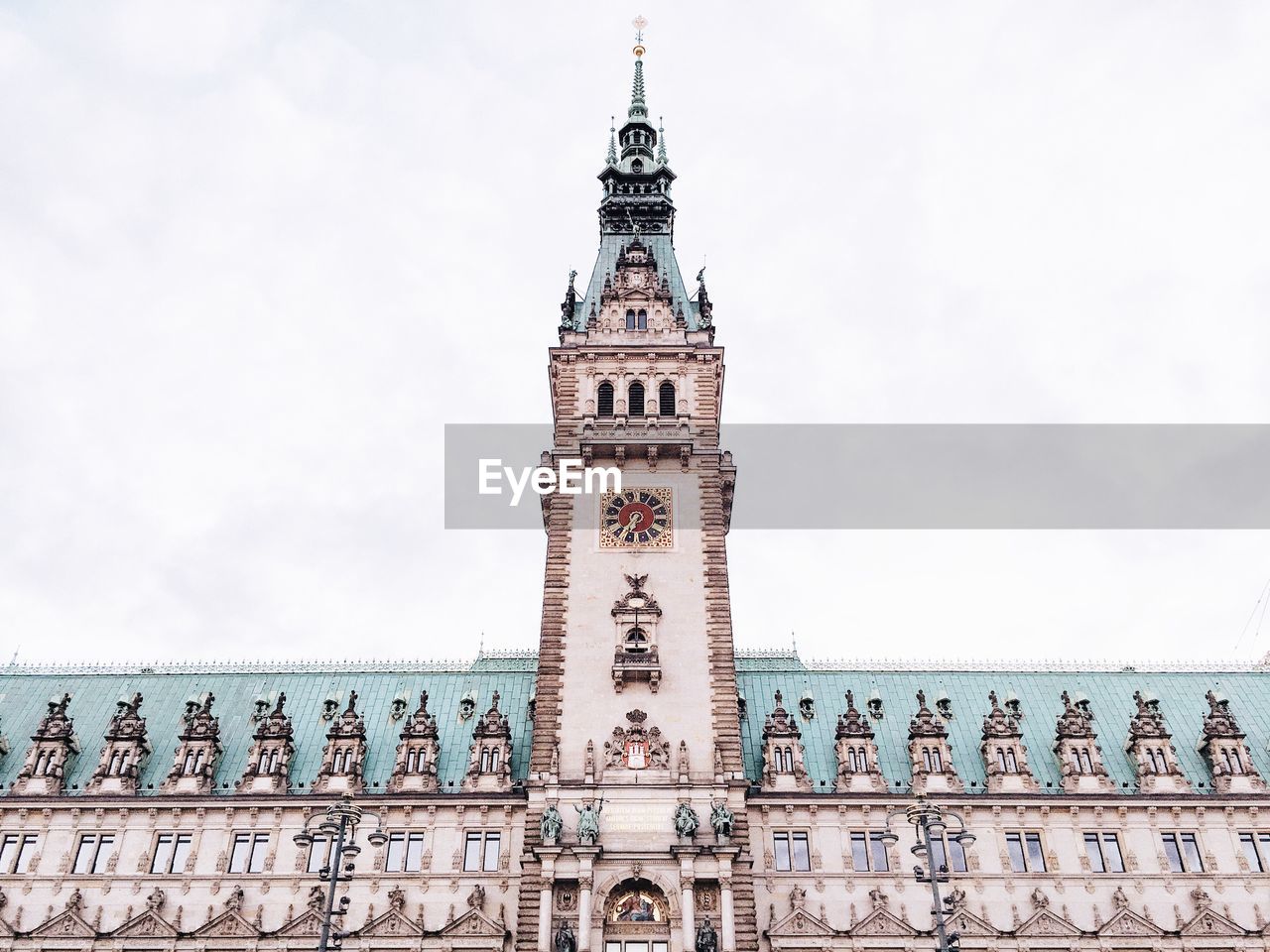 Clock tower against cloudy sky