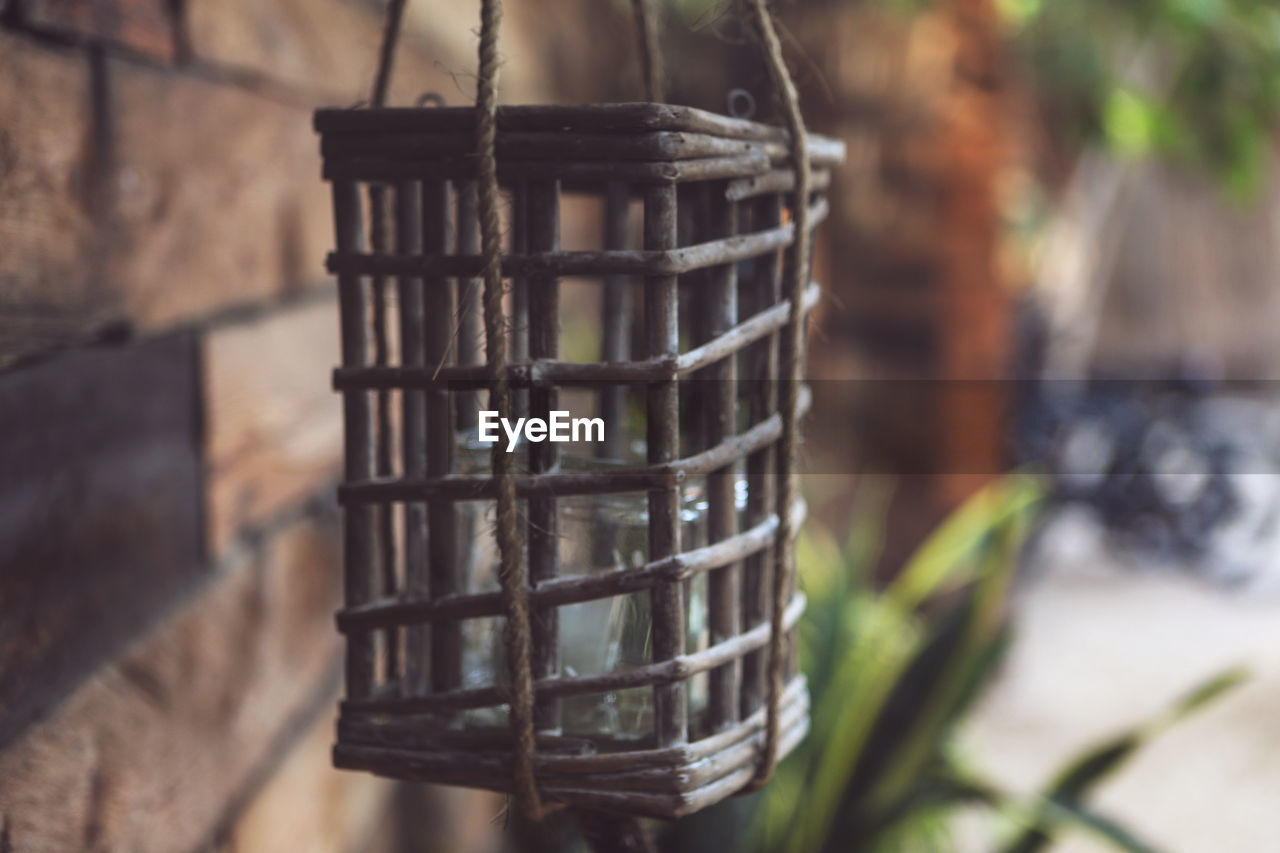 Close-up of old-fashioned oil lamp hanging outdoors