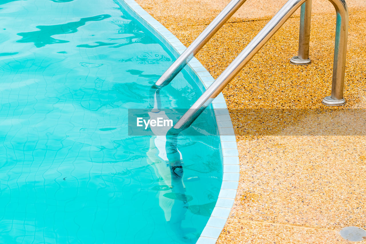 HIGH ANGLE VIEW OF SWIMMING POOL BY PLAYGROUND