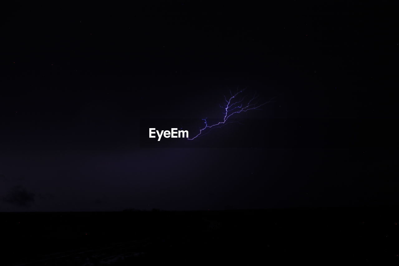 LOW ANGLE VIEW OF LIGHTNING AGAINST SKY