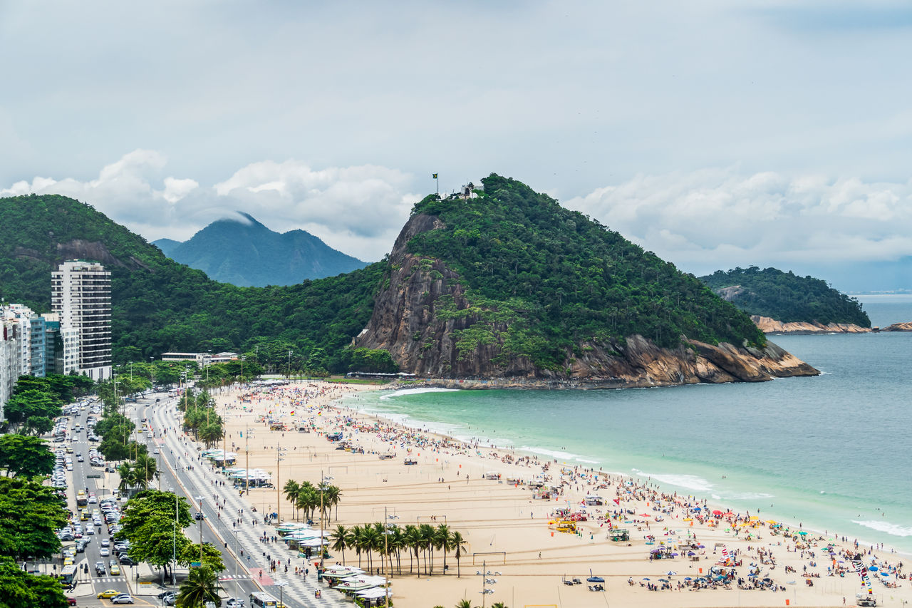 Scenic view of sea and mountains against sky