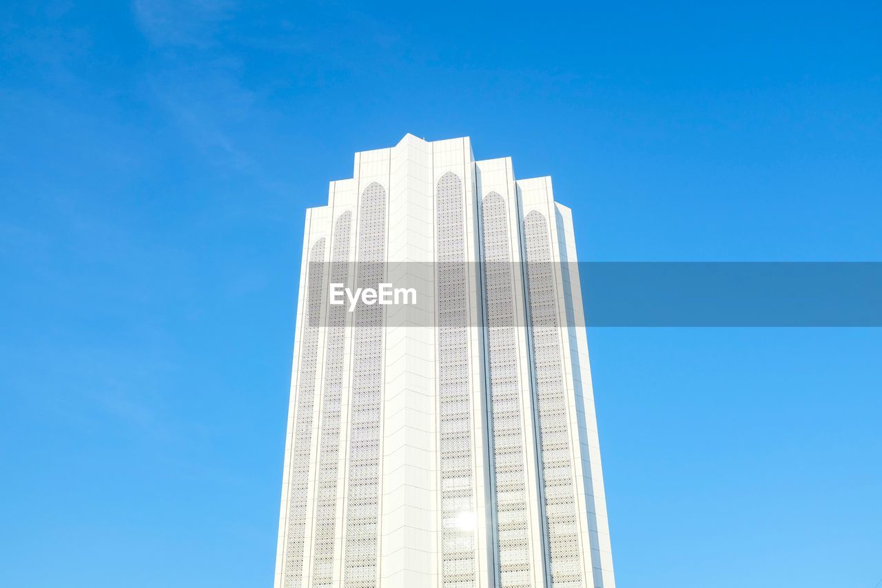 LOW ANGLE VIEW OF SKYSCRAPERS AGAINST BLUE SKY