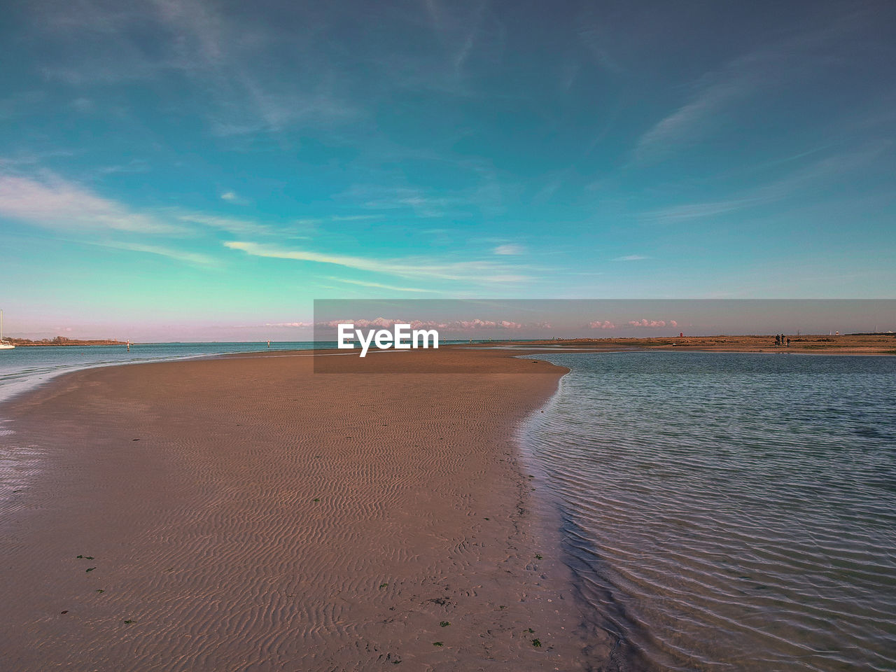 Scenic view of beach against blue sky