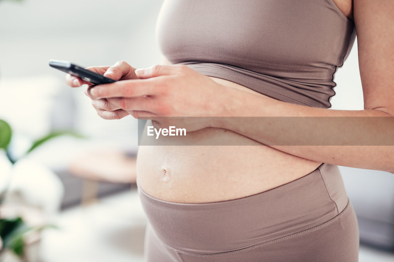 midsection of woman using phone