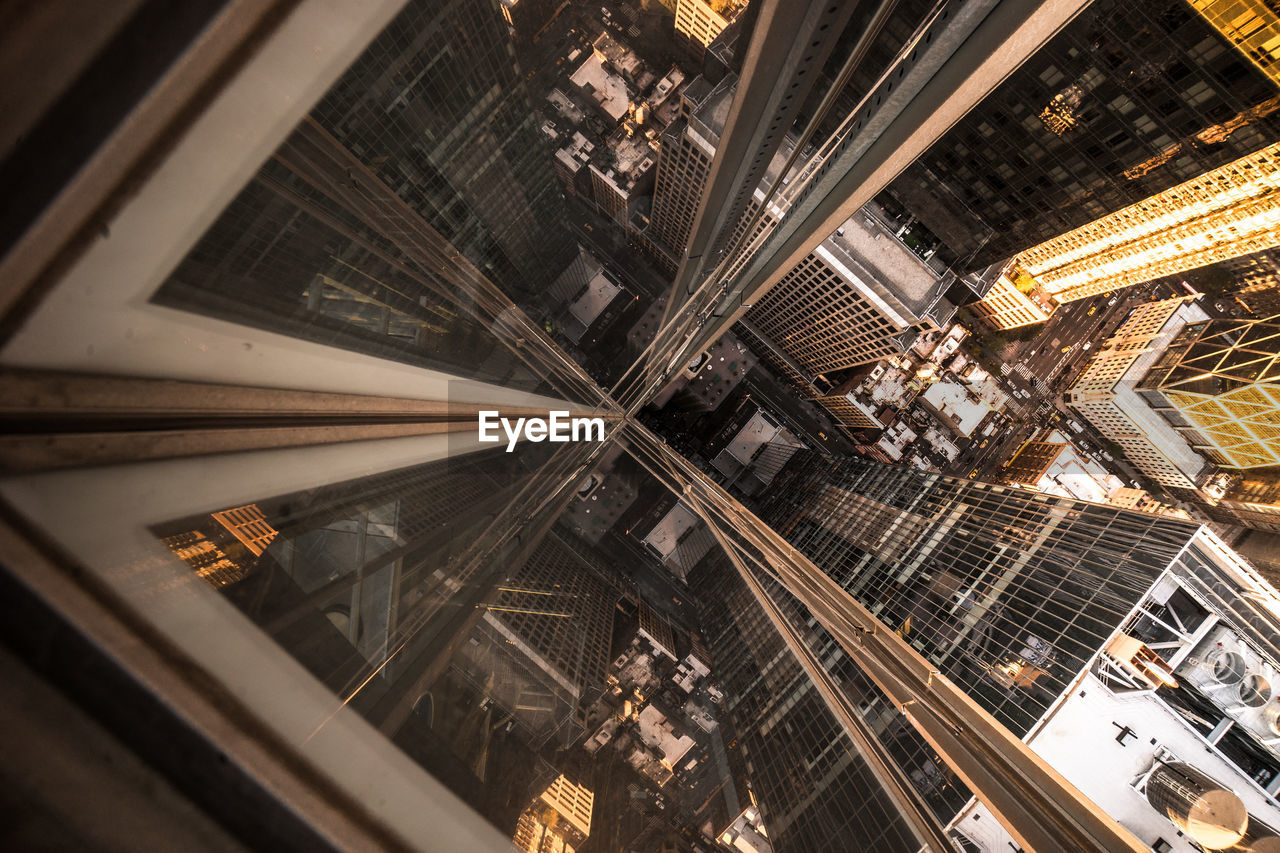 High angle view of buildings in city seen through glass elevator