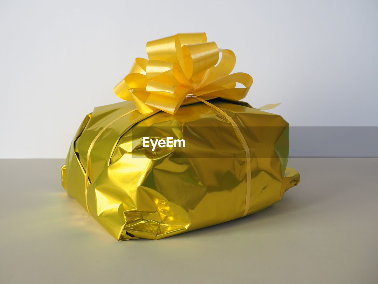 yellow, gift, paper, gold, studio shot, ribbon, art, wrapped, wrapping paper, indoors, surprise, bow, no people, tied bow, celebration, present, petal, origami paper, origami, box, copy space, single object, gift box, wedding favors, container, holiday, shiny, emotion