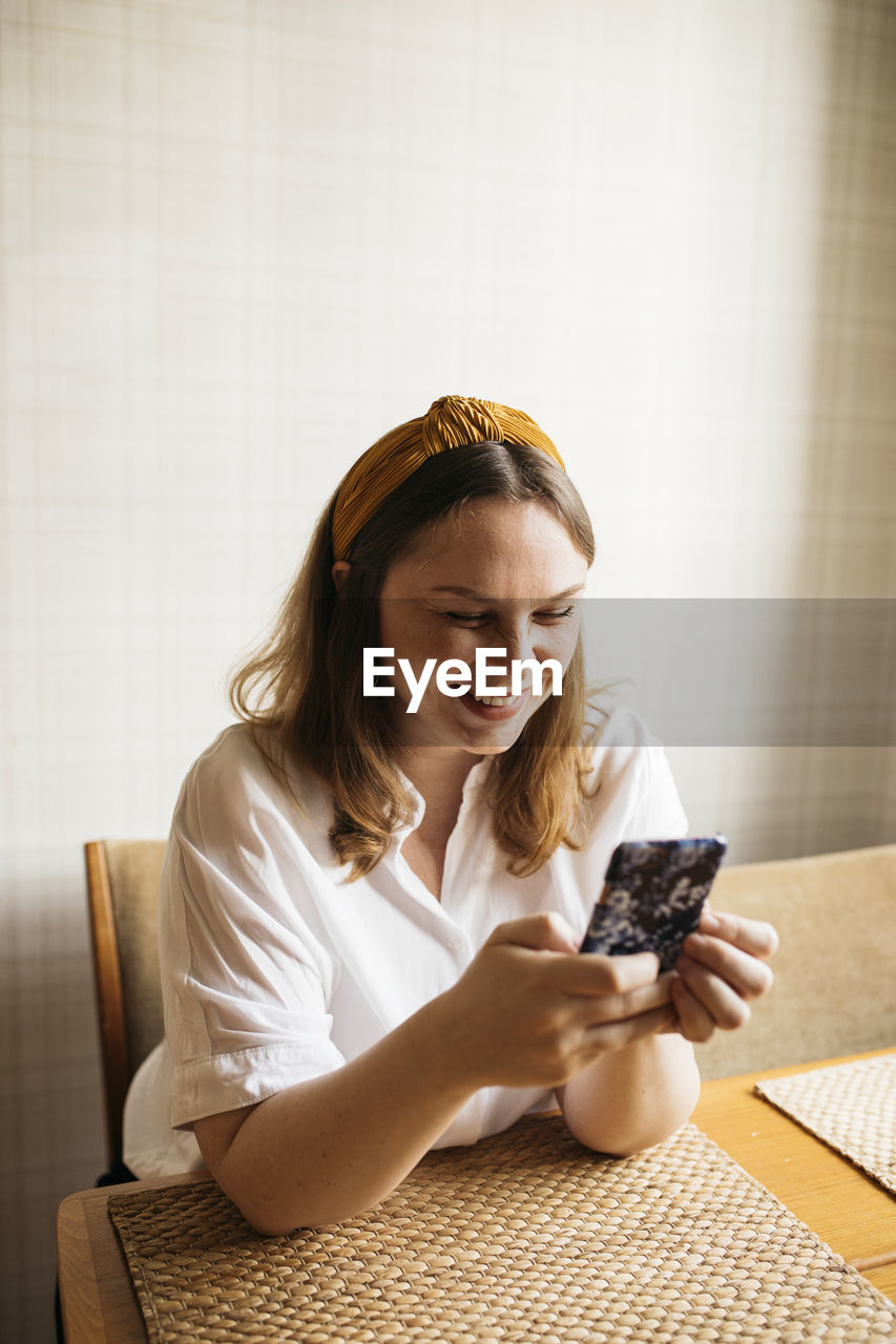 Smiling woman using cell phone