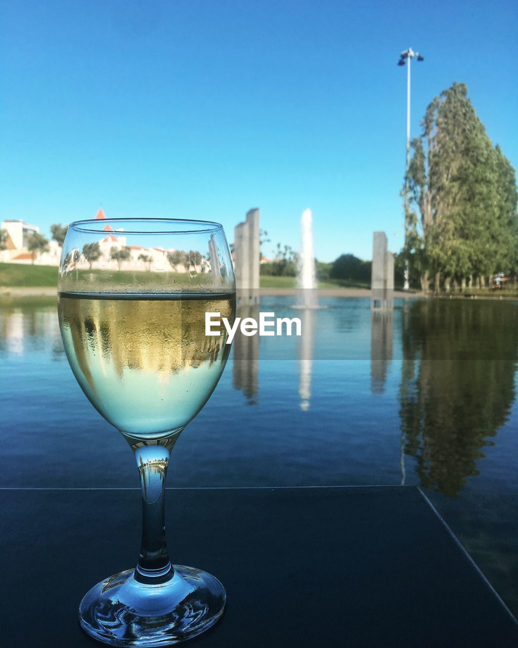 CLOSE-UP OF WINE GLASS AGAINST CLEAR SKY