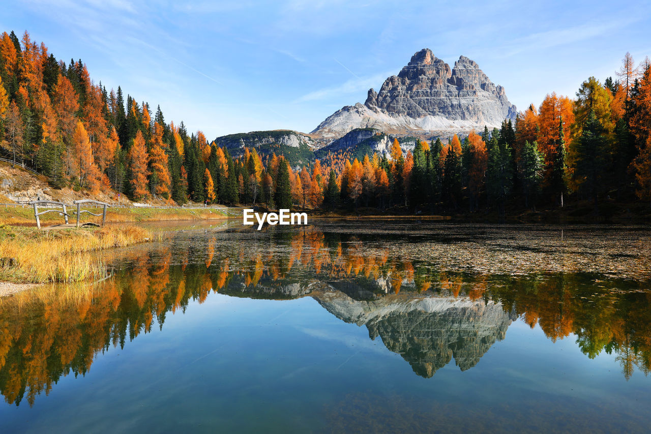 Scenic view of lake by trees against sky during autumn