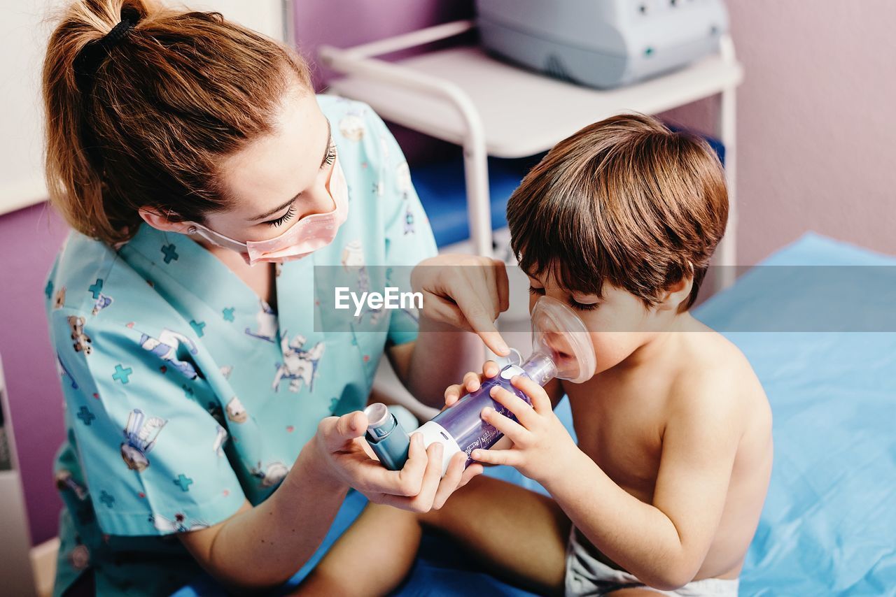 Sick boy getting inhalation treatment in clinic