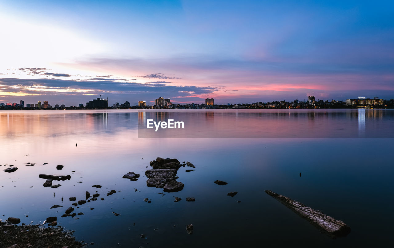 Scenic view of lake against sky during sunset