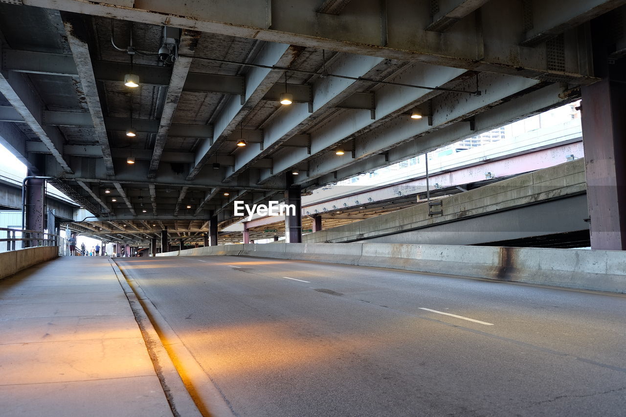 Empty road under bridge