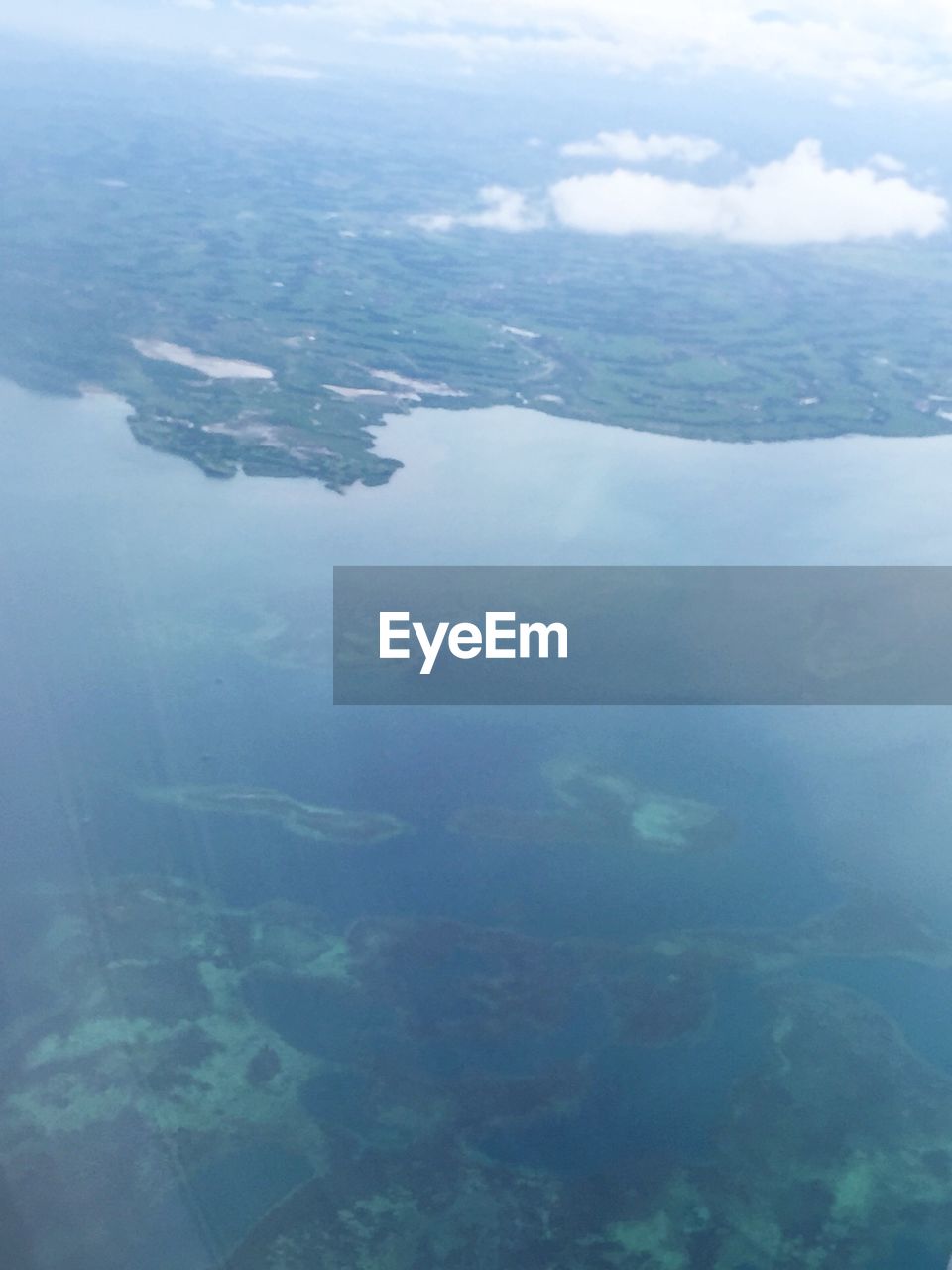 Aerial view of landscape against cloudy sky