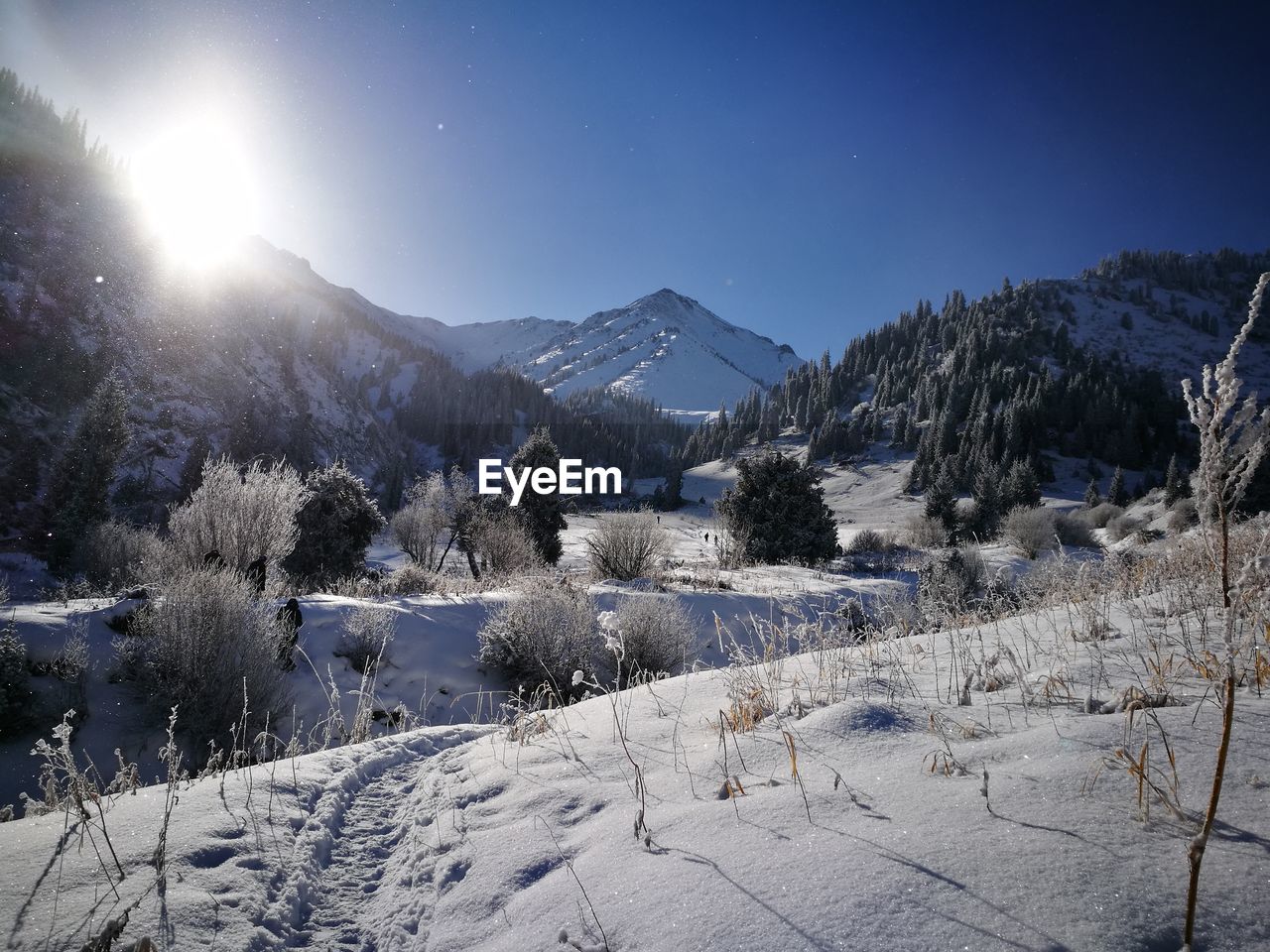 Scenic view of snowcapped mountains against clear sky