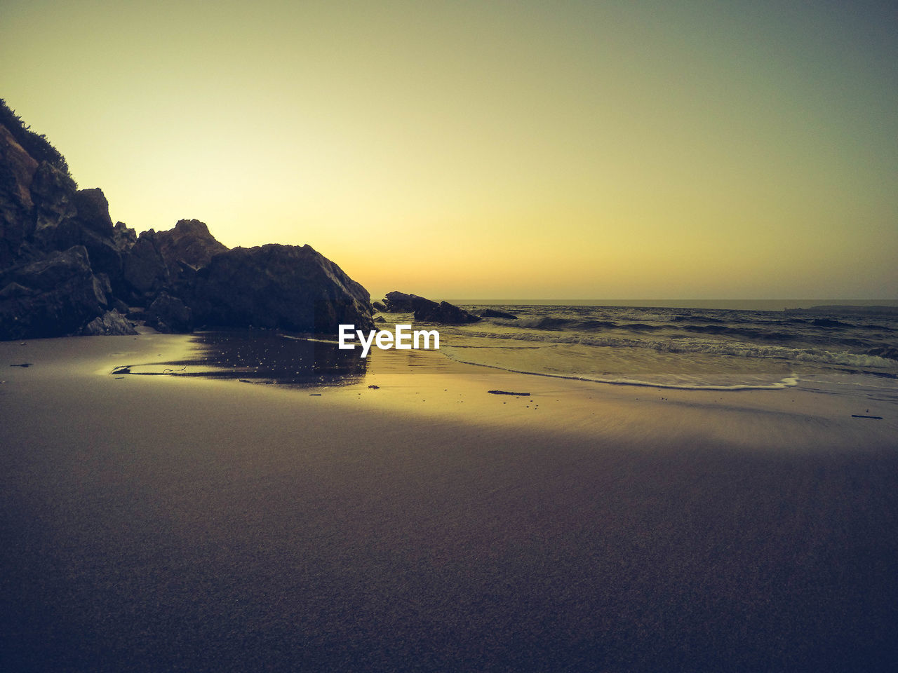 Scenic view of beach against clear sky