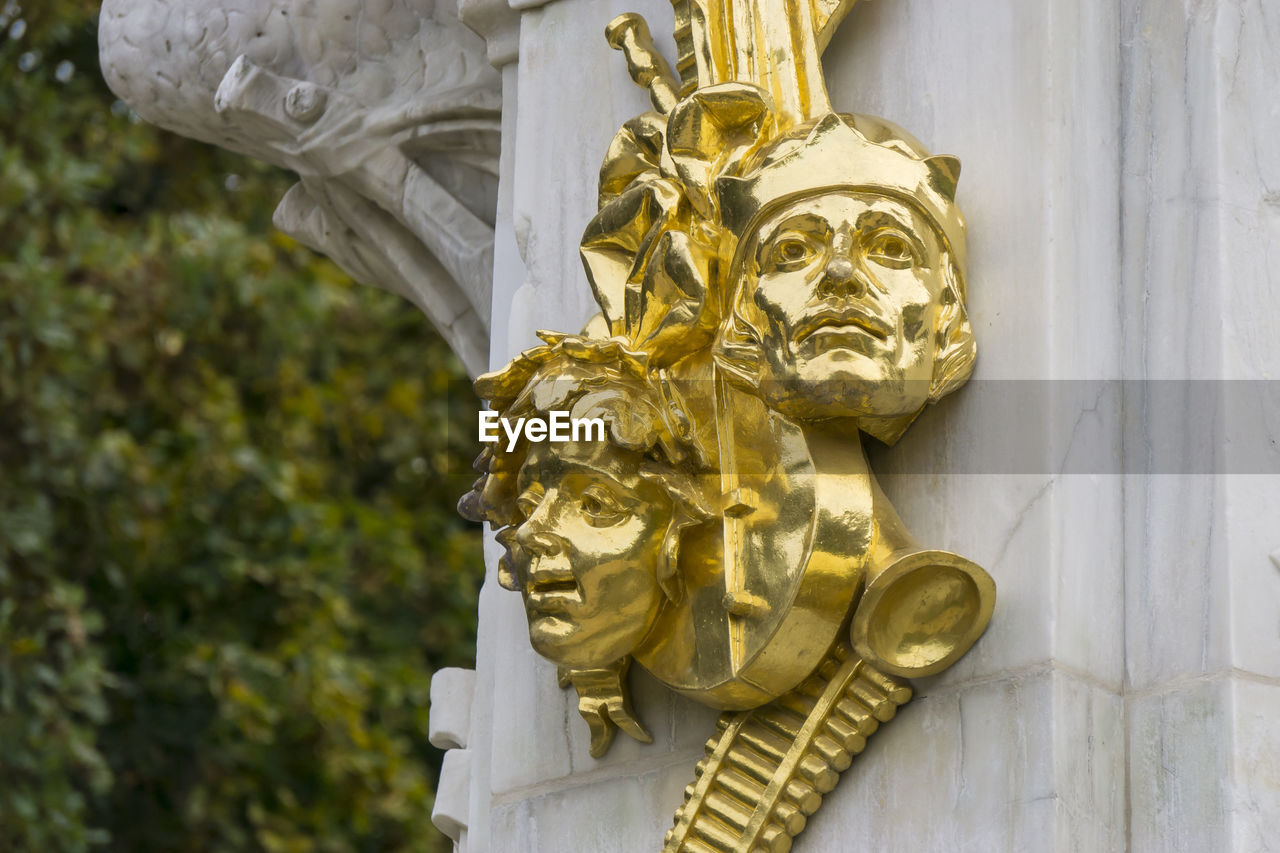 Closeup of gilded sculptures as part of the Beethoven-Haydn-Mozart Memorial at Tiergarten Park in Berlin, Germany Beethoven-Haydn-Mozart Memorial Berlin Classical Music Closeup Germany Gilded Gold Colored Heads Horizontal Outdoors Photography Sculpture Tiergarten