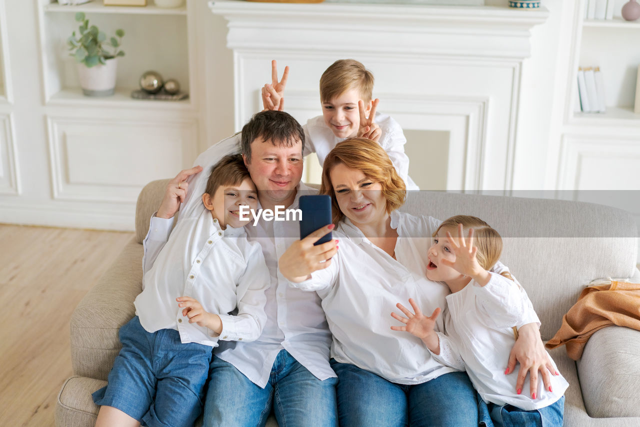 Portrait caucasian cheerful family happy parents and little children taking