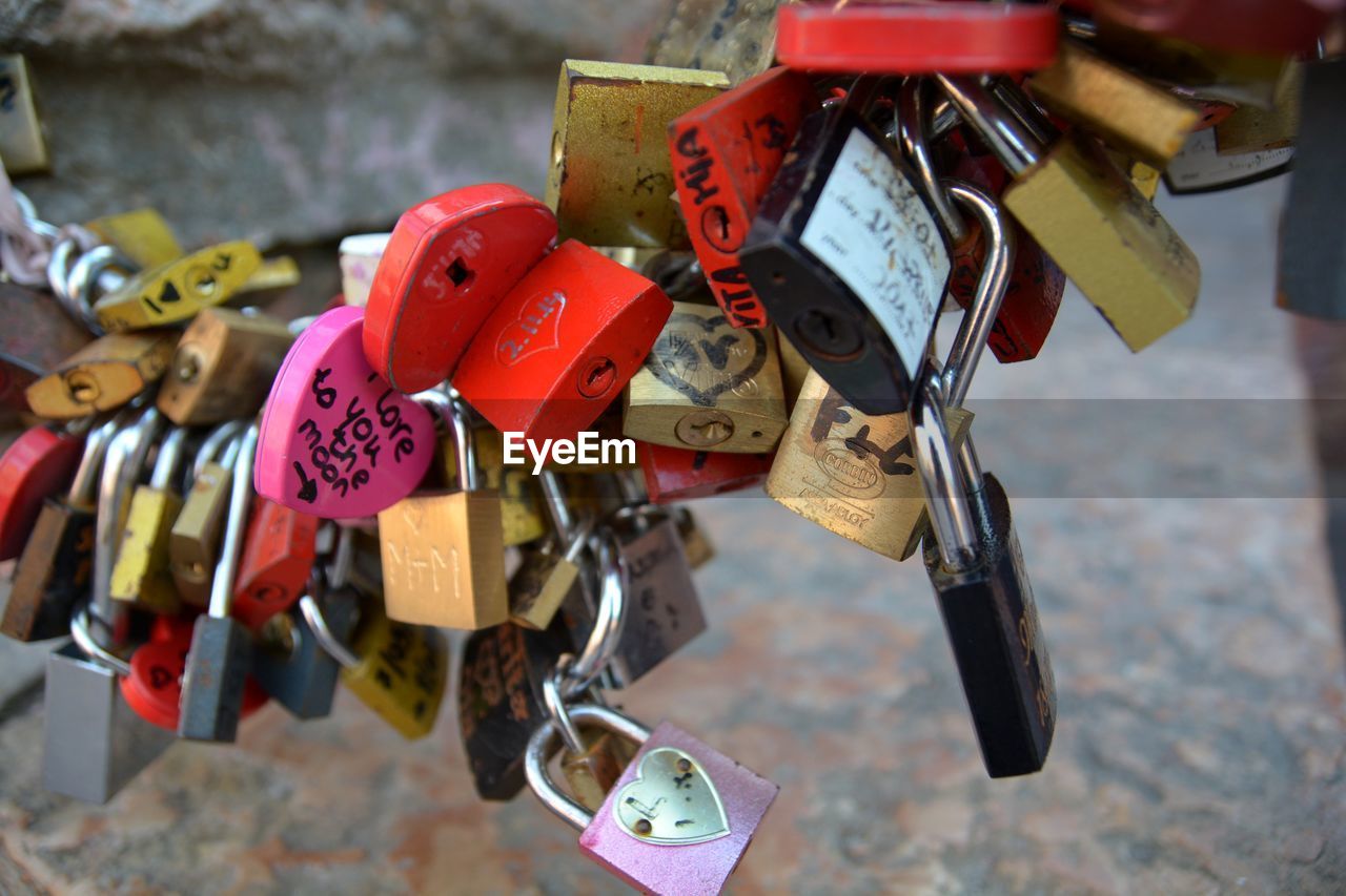 Close-up of padlocks hanging on railing