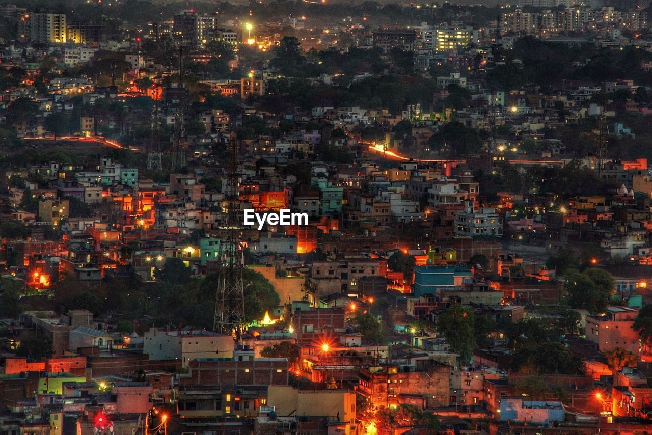 High angle view of city lit up at night