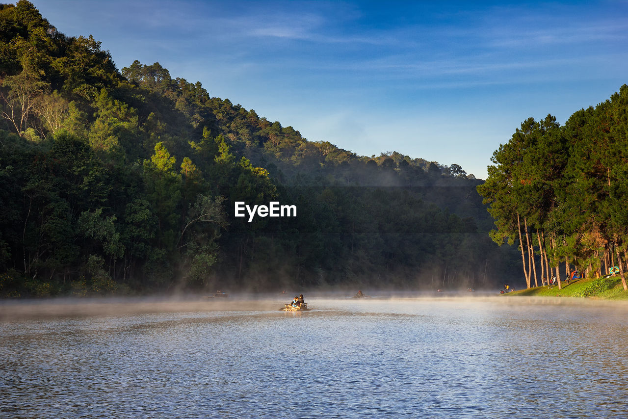 SCENIC VIEW OF LAKE BY TREE MOUNTAIN AGAINST SKY