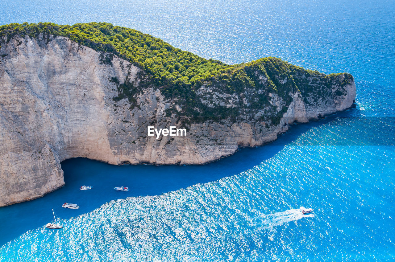 HIGH ANGLE VIEW OF ROCK FORMATIONS ON SEA SHORE