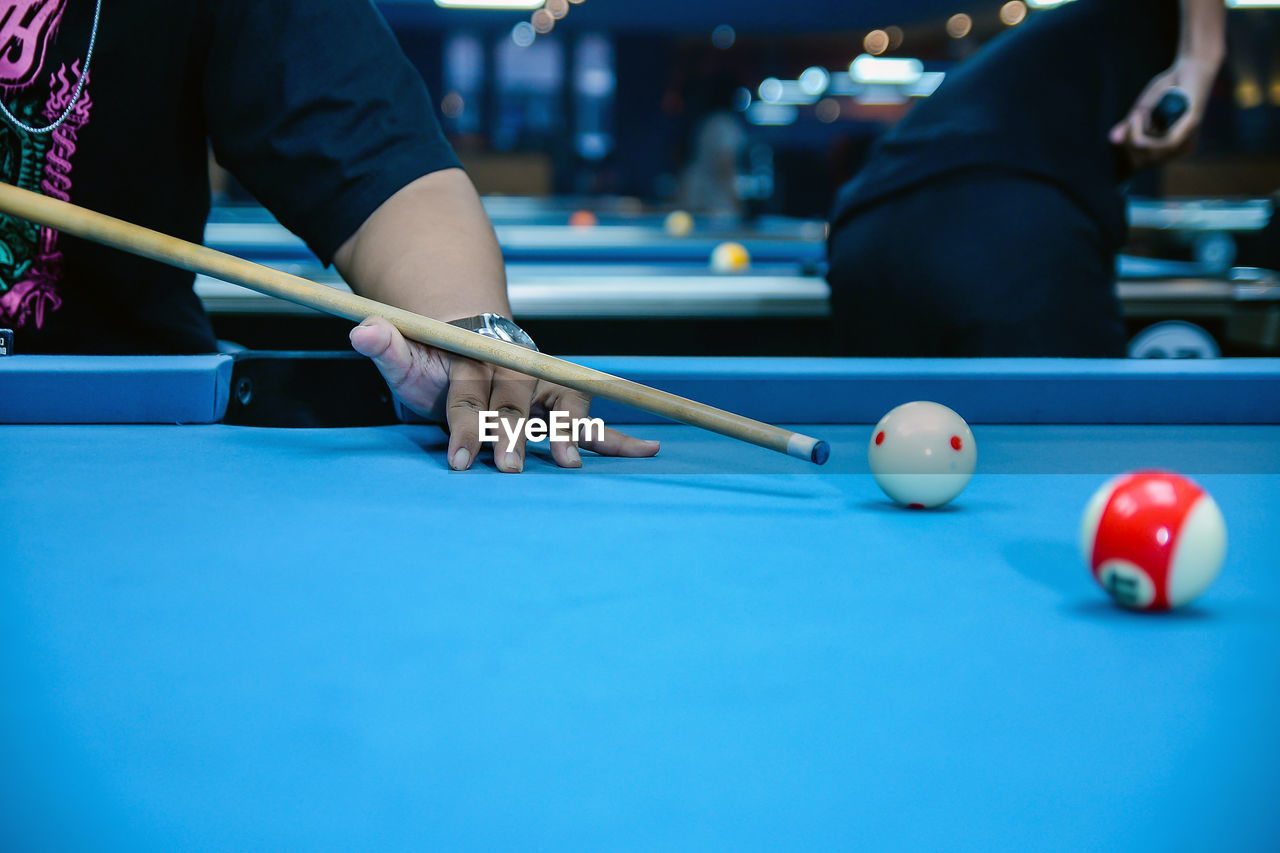 cropped image of man playing pool
