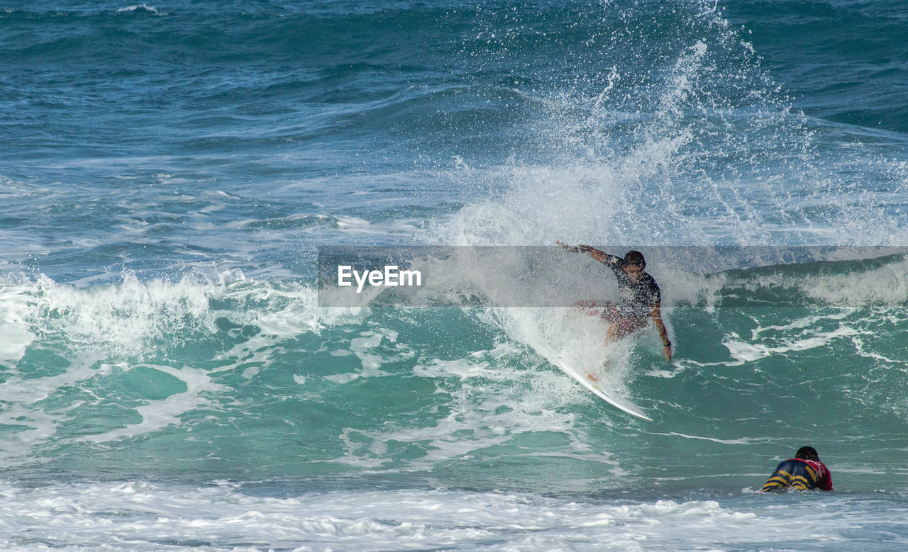 MAN SURFING IN SEA