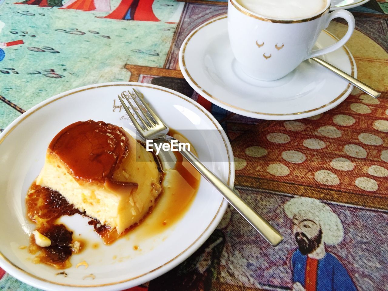 High angle view of caramel custard and coffee cup on table