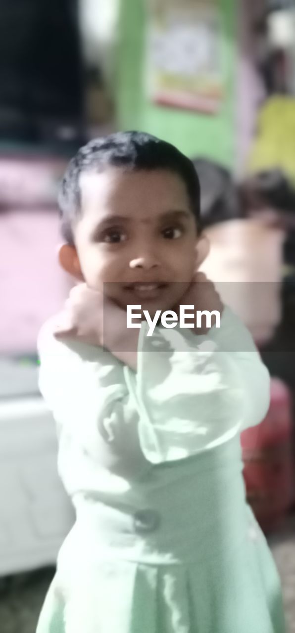 PORTRAIT OF SMILING GIRL STANDING