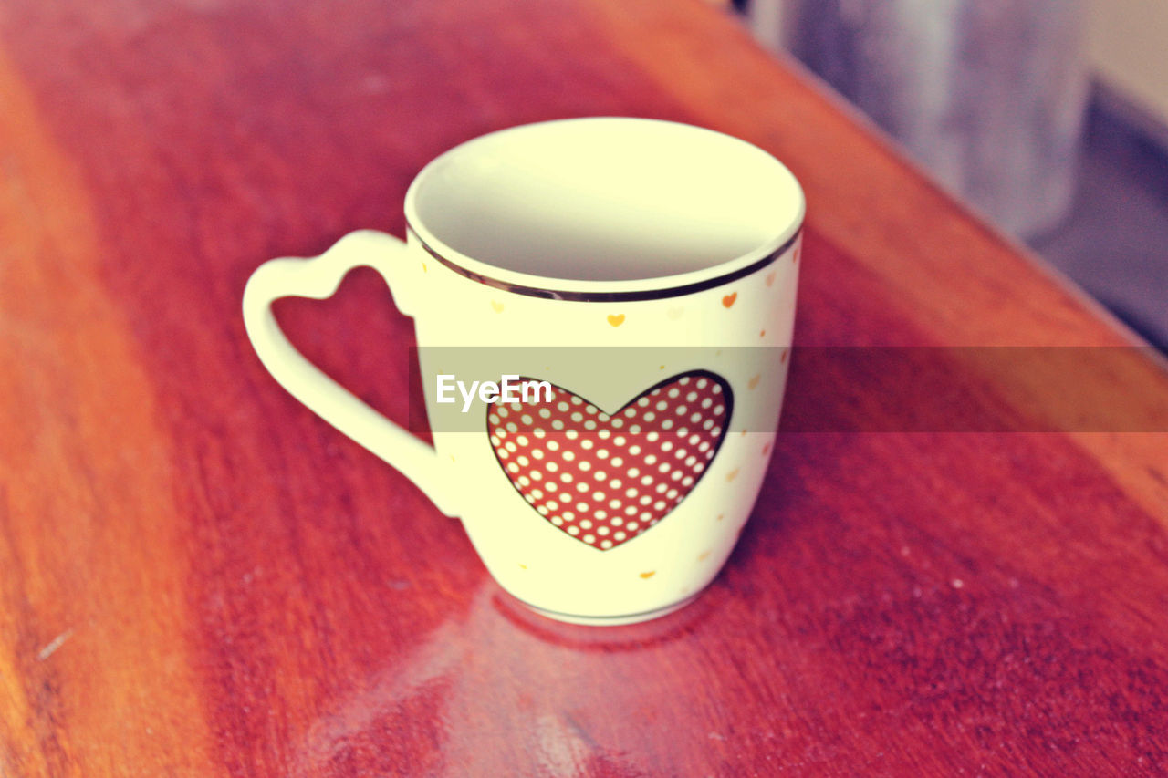 Mug with heart on table