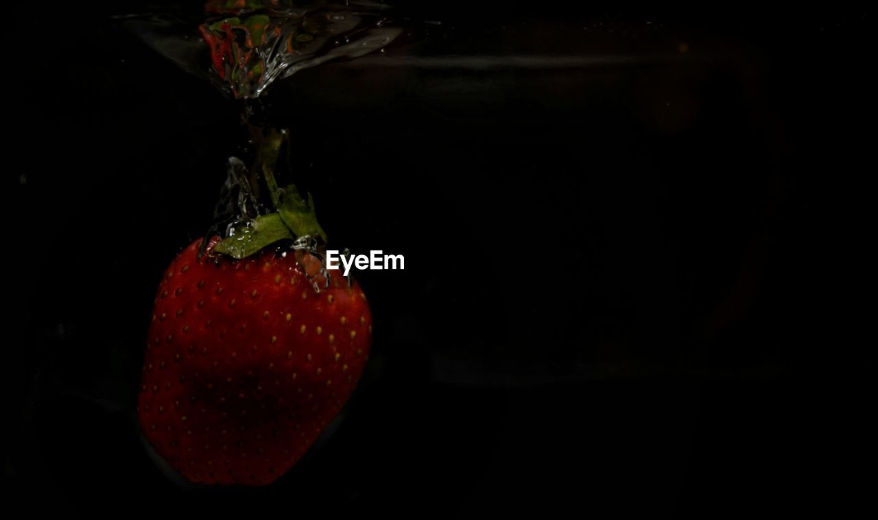 Close-up of strawberry against black background