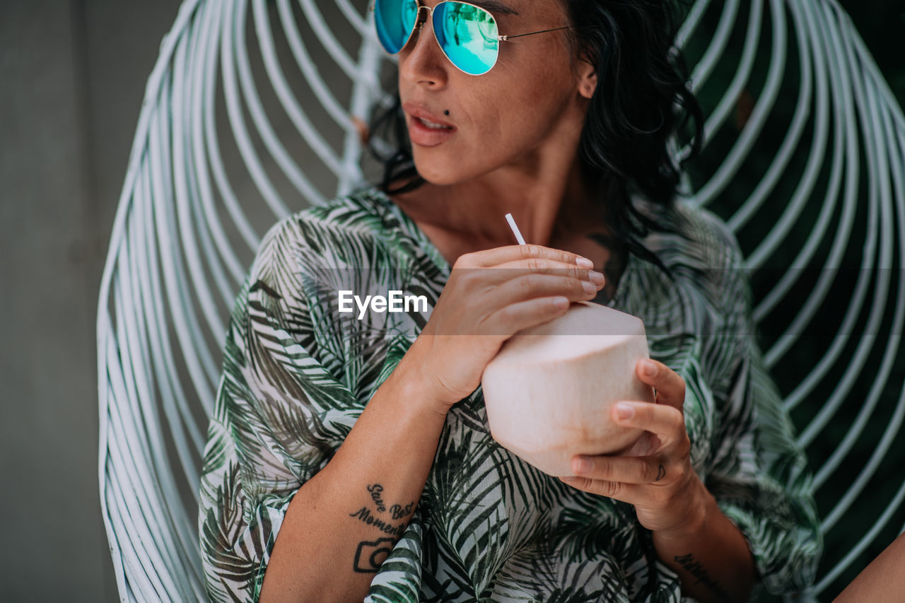 Midsection of a woman drinking glass