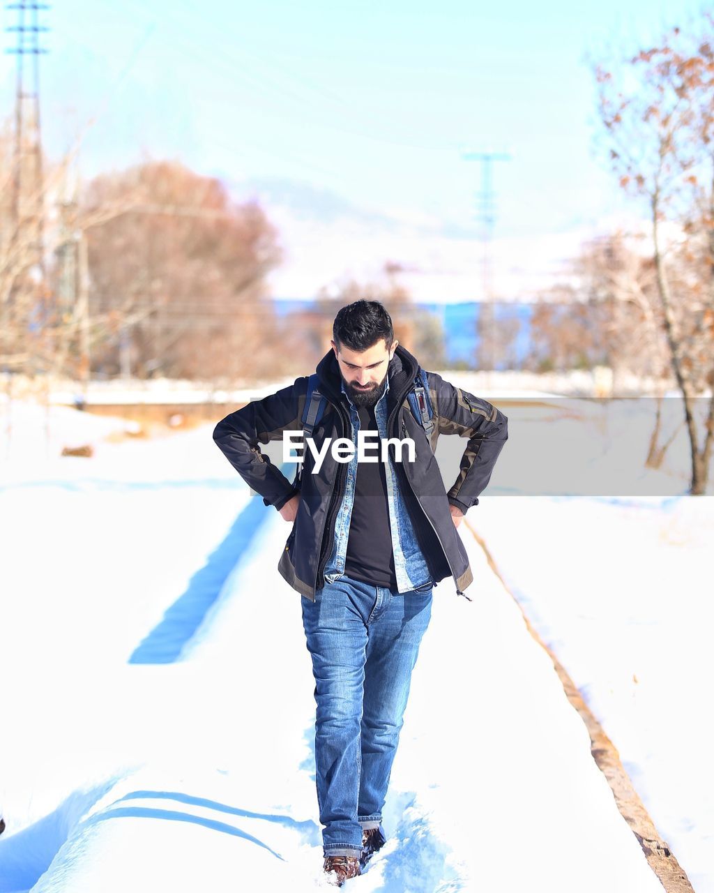 Full length of young man walking on snow