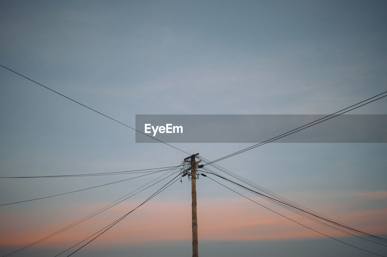 Low angle view of electricity pylon against sky