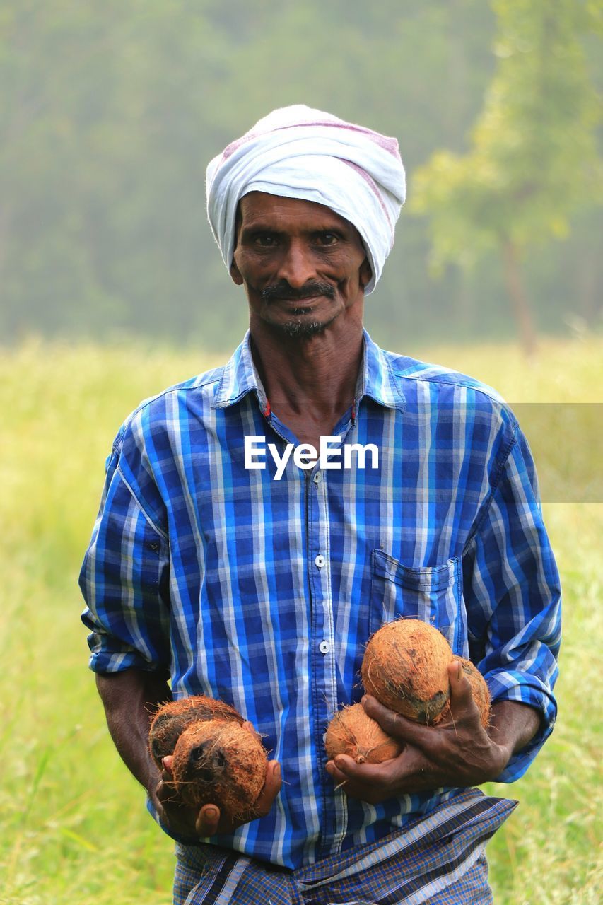 Portrait of man standing on field