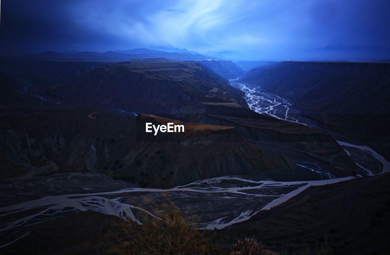 Scenic view of river amidst canyon against sky