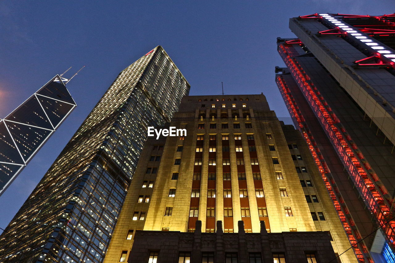 Low angle view of illuminated buildings against sky at dusk