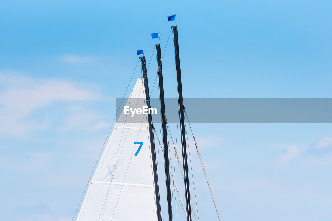 Low angle view of boat mast against sky