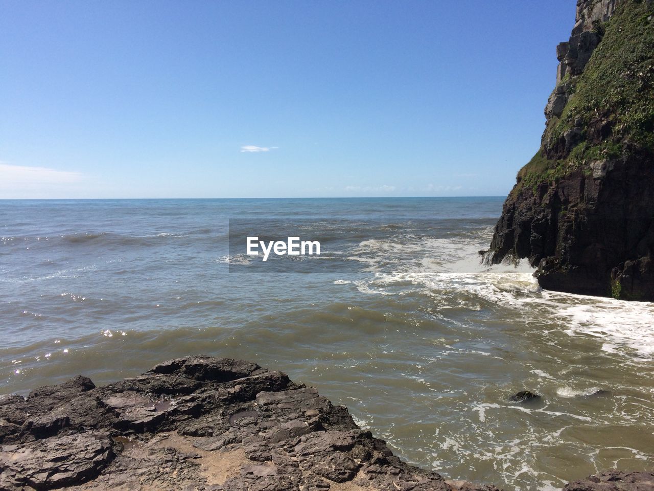 Rock formations by sea against sky