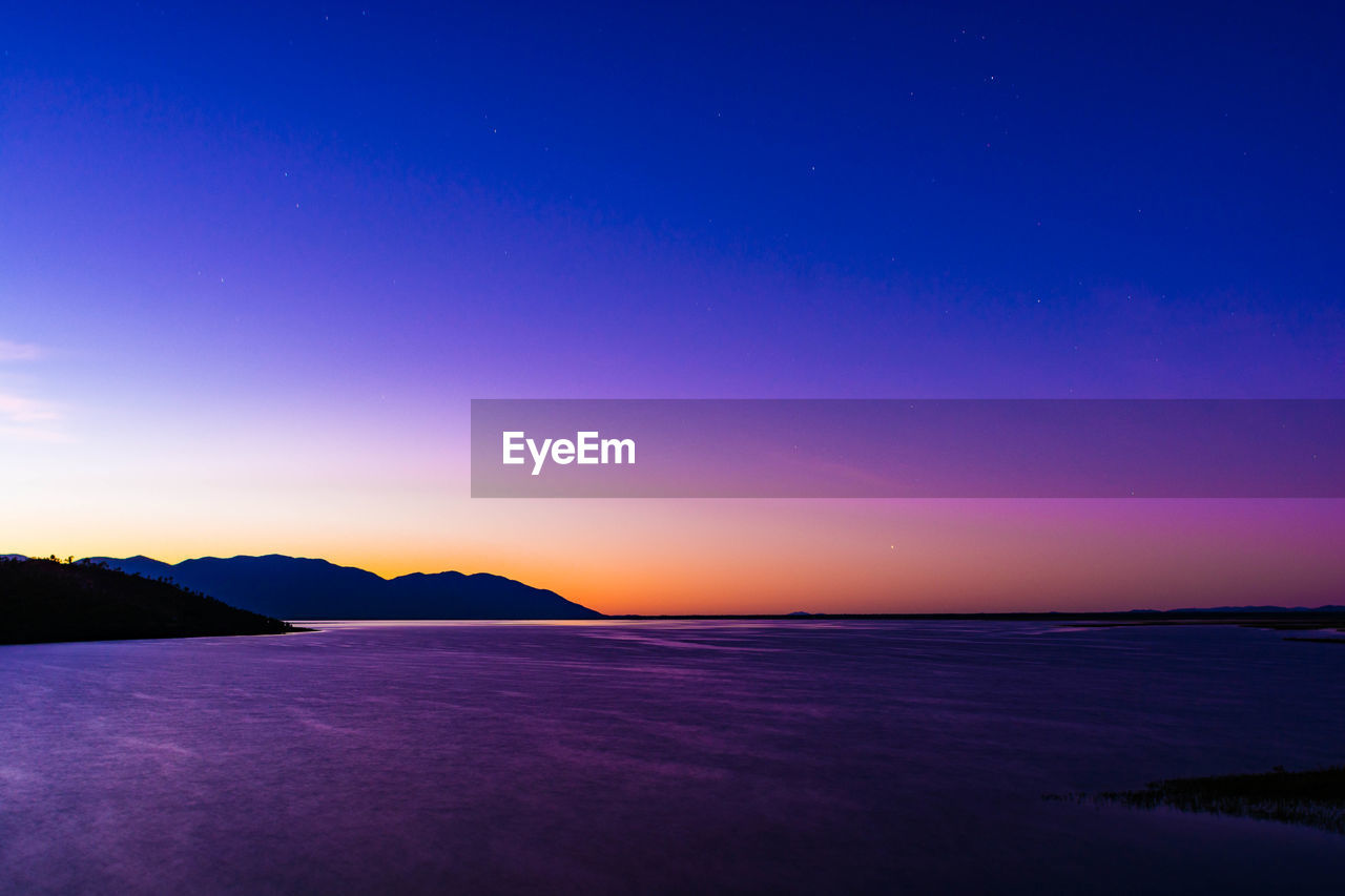 Scenic view of sea against sky at sunset