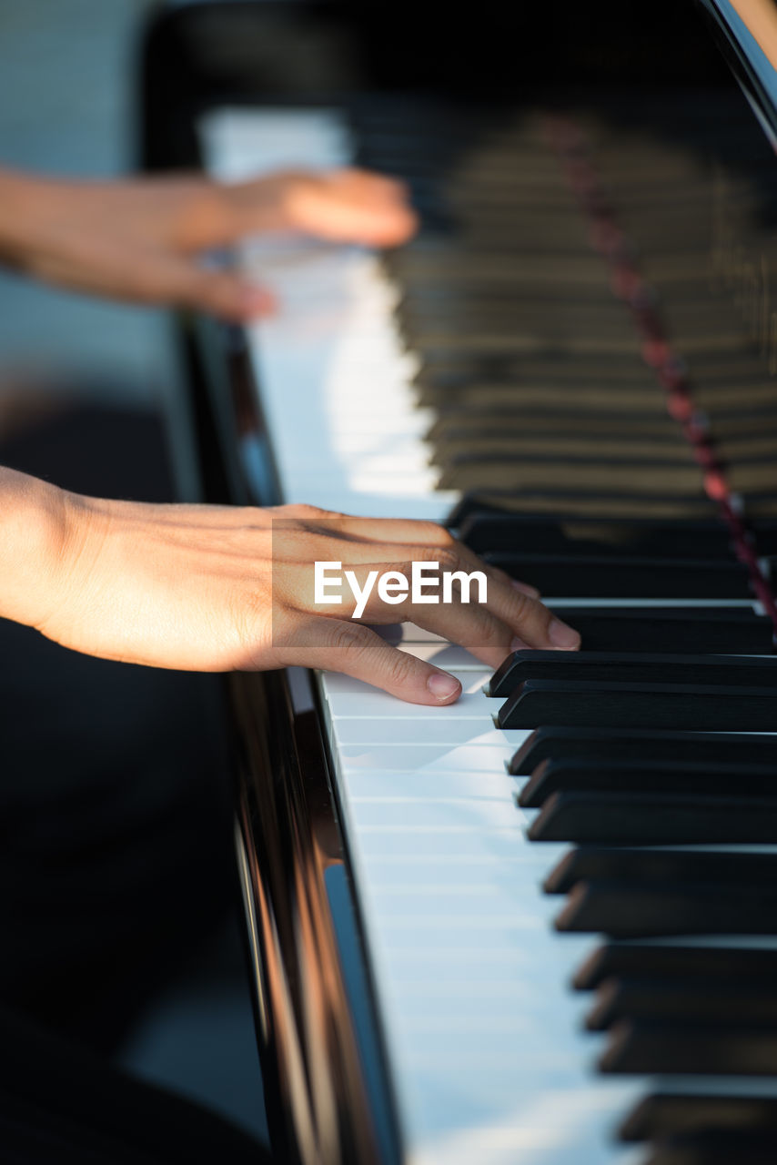 Cropped image of pianist playing piano