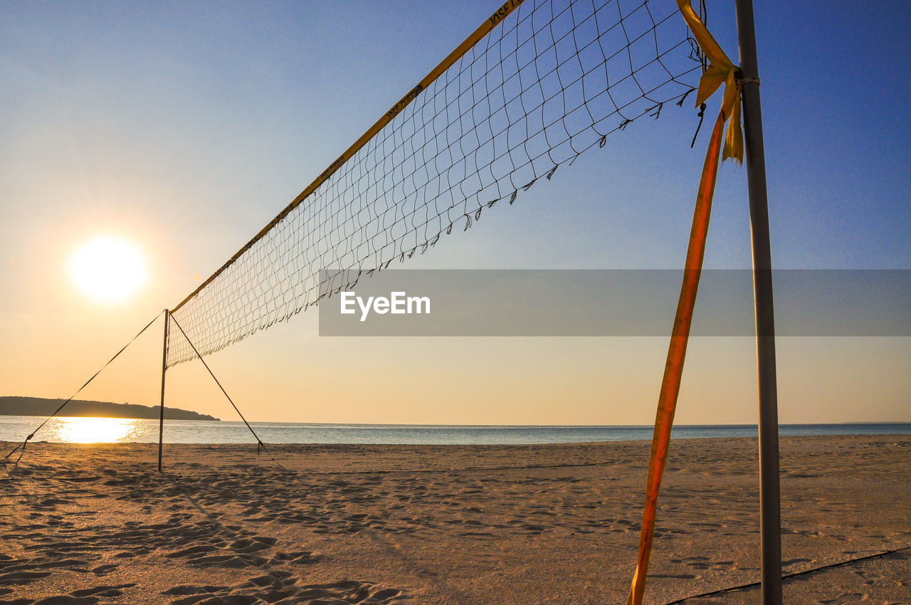 Scenic view of beach against sky during sunset