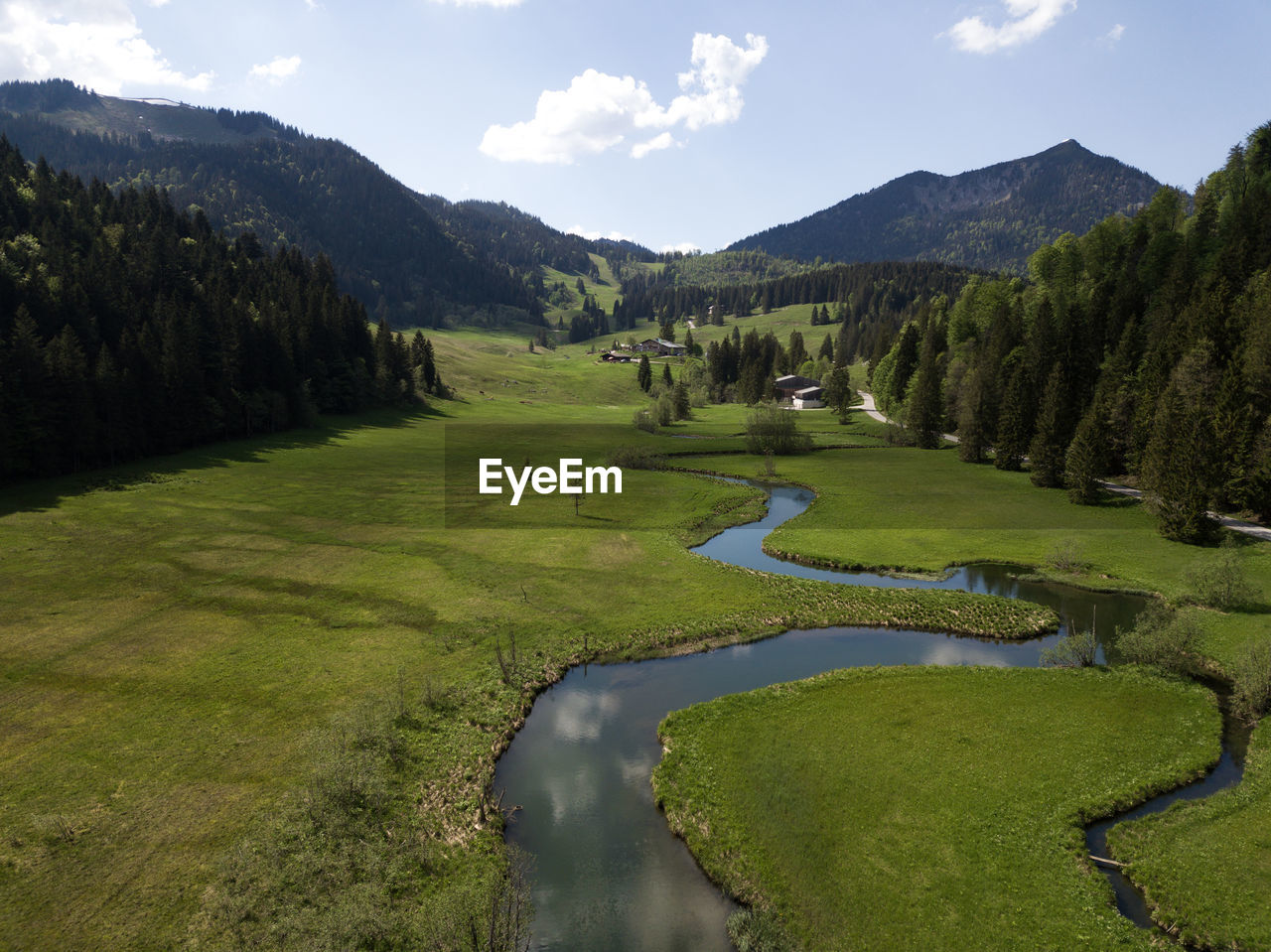 River flowing through green grass in the bavarian alps