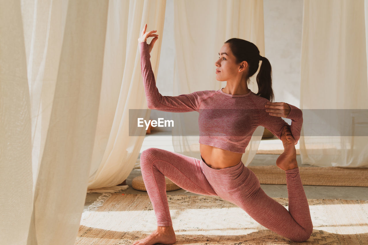 Young woman doing yoga at home