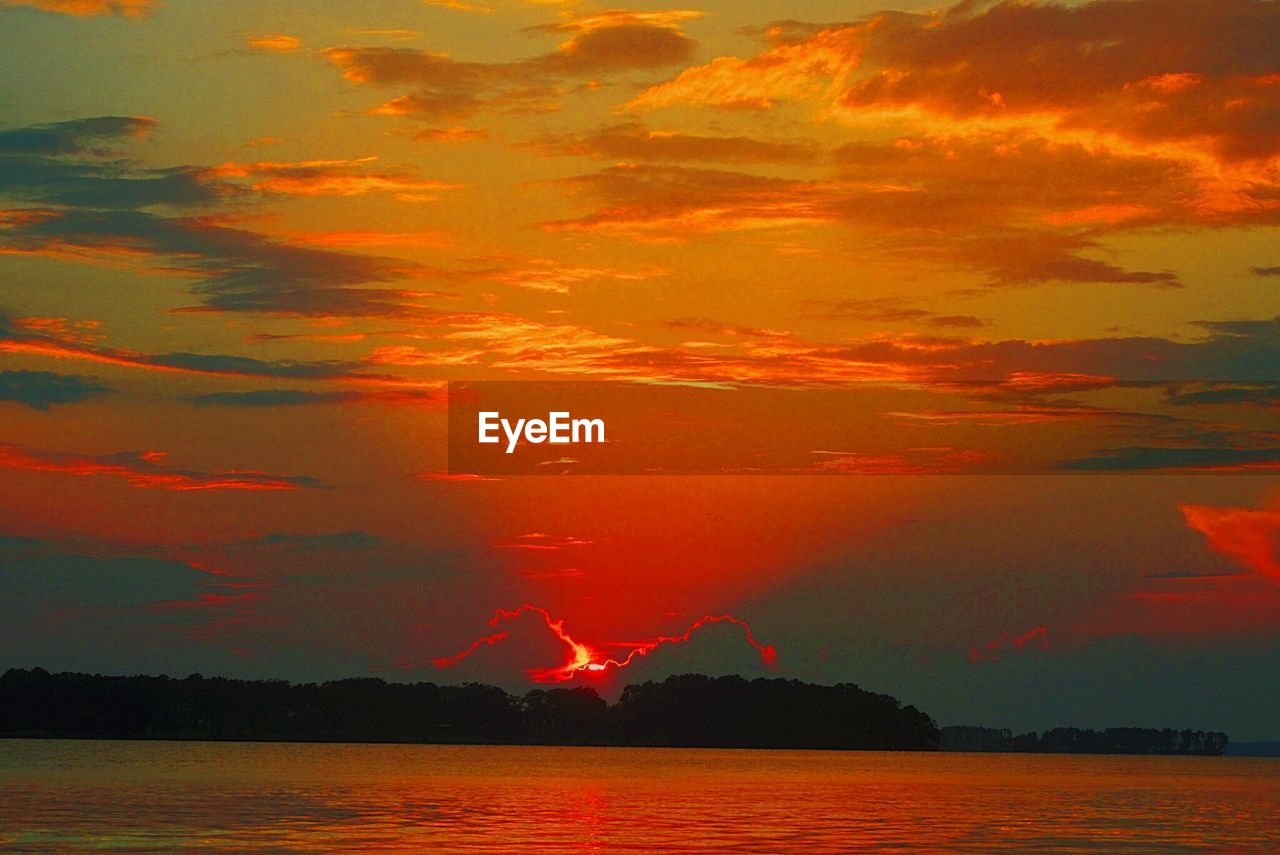 Scenic view of lake against sky during sunset