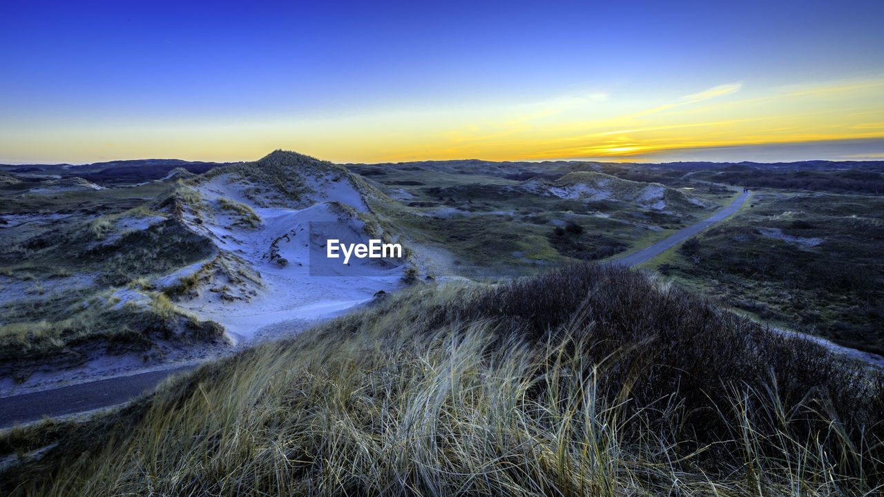 Scenic view of snow mountains against sky during sunset