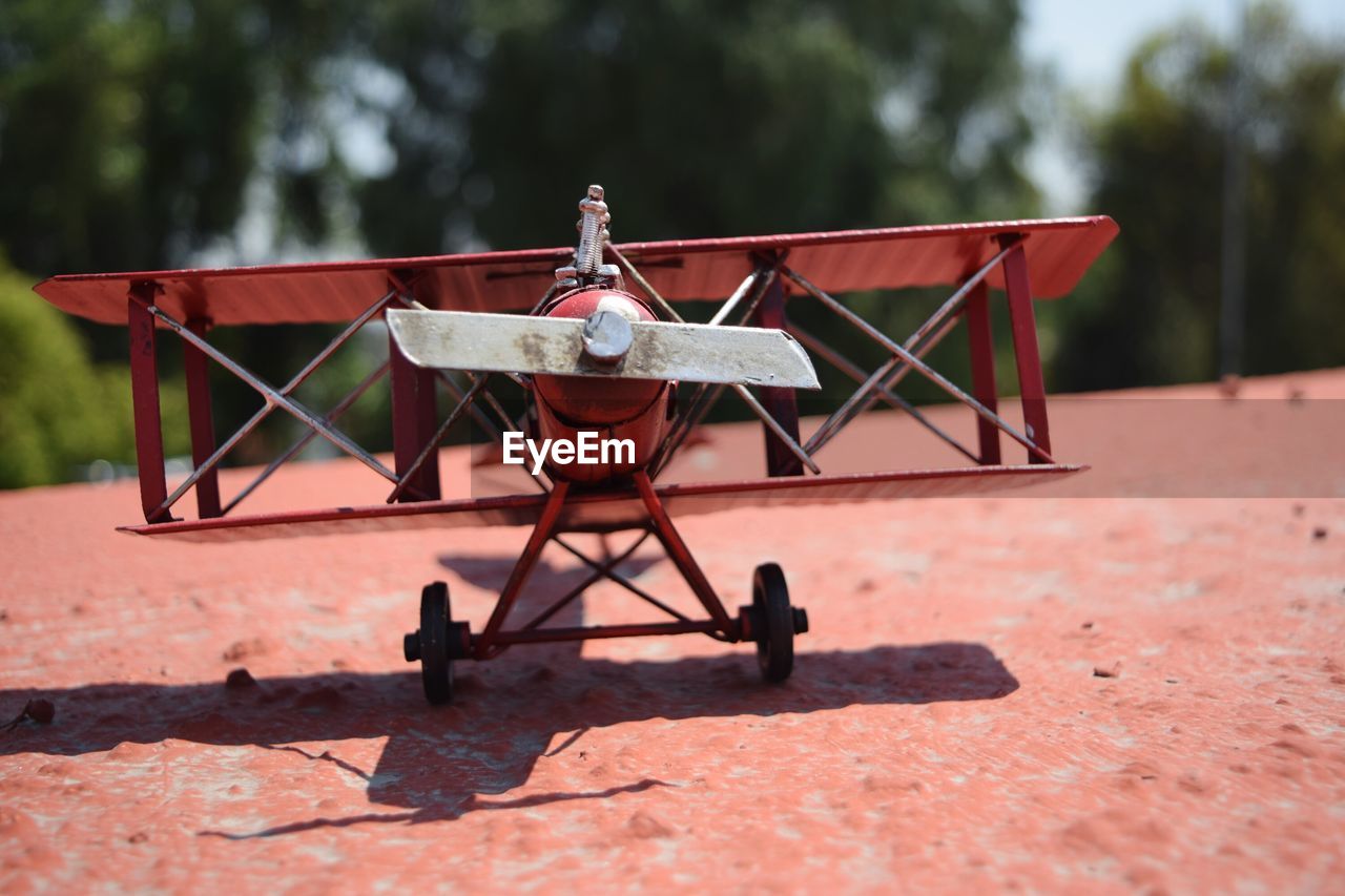 Close-up of toy airplane on retaining wall